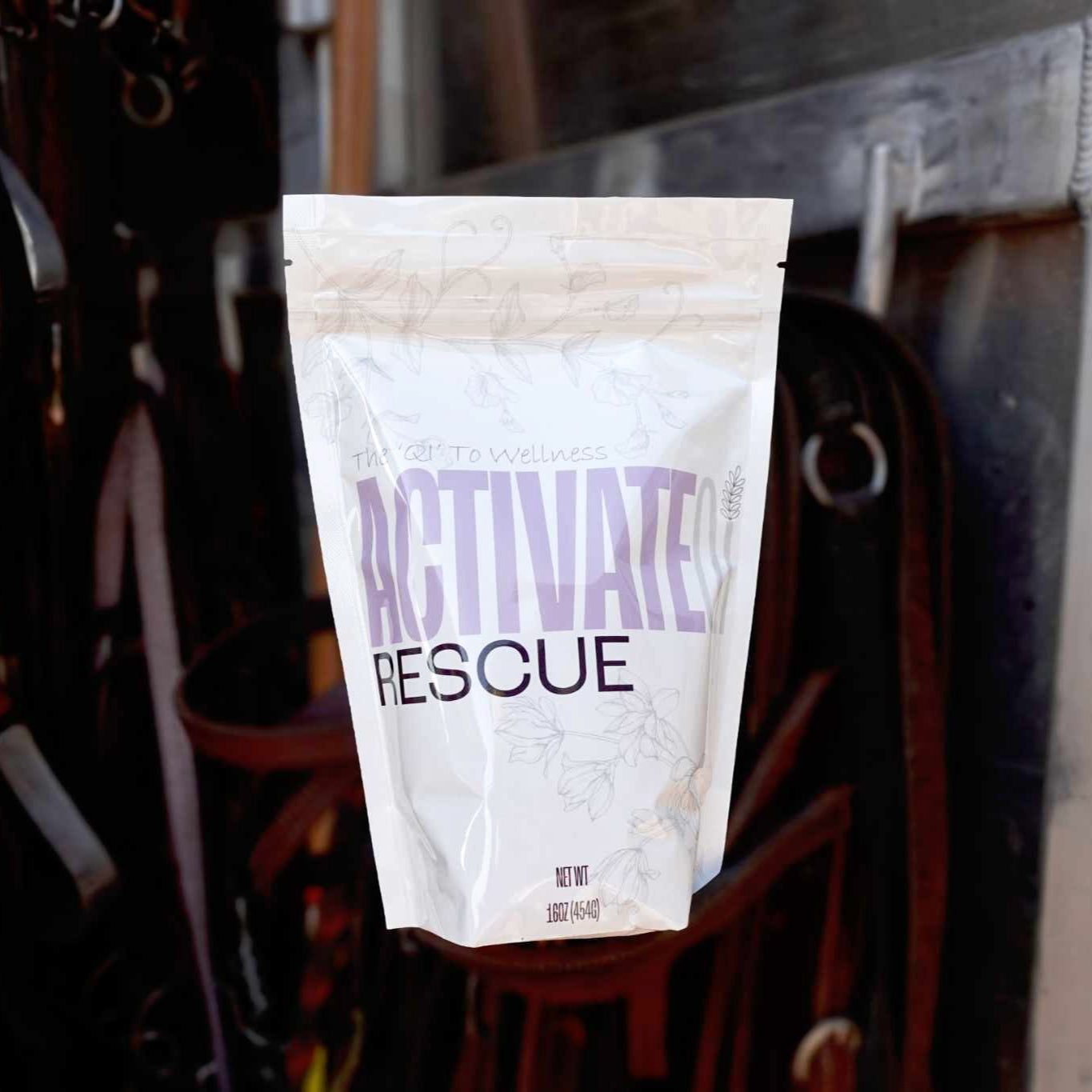 Package labeled ActivateQi Rescue hanging on a metal surface with a blurred background