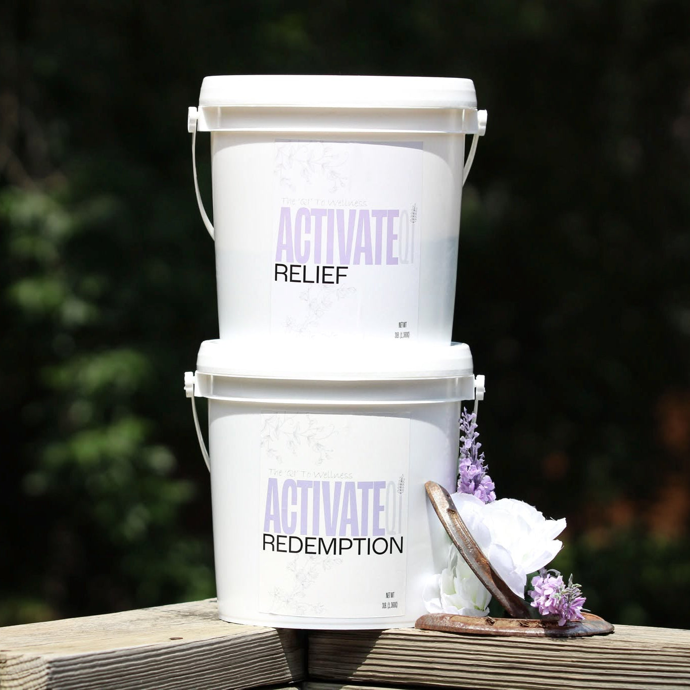 Three white buckets of Equine Supplements from ActivateQi with text on a wooden surface outdoors