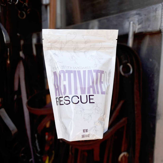 Package labeled ActivateQi Rescue hanging on a metal surface with a blurred background